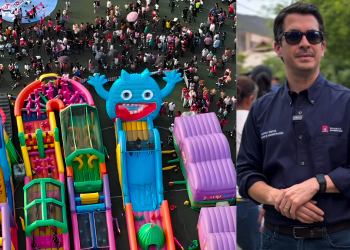 Aerial View of a Crowded Outdoor Festival with Bright Inflatable Slides; a Man Wearing Sunglasses Stands on the Right Side with Folded Arms in a Dark Shirt. - Adelante Mty