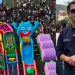 Aerial View of a Crowded Outdoor Festival with Bright Inflatable Slides; a Man Wearing Sunglasses Stands on the Right Side with Folded Arms in a Dark Shirt. - Adelante Mty