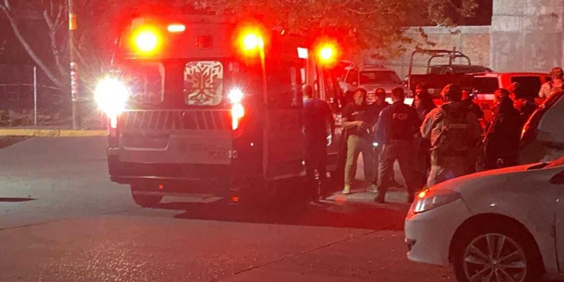 Ambulance with Flashing Red Lights on a Street at Night, a Crowd of People Behind Police Tape. - Adelante Mty