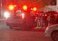 Ambulance with Flashing Red Lights on a Street at Night, a Crowd of People Behind Police Tape. - Adelante Mty