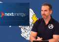 Speaker in a Black Polo with an Avengers Logo Presents Nextenergy Branding over a Blue Map Backdrop. - Adelante Mty
