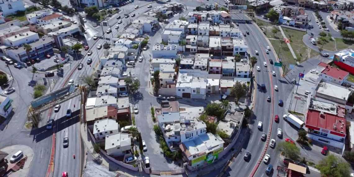 Aerial View of a Dense Urban Neighborhood with Curved Roads and White Buildings. - Adelante Mty