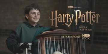 Boy with Glasses in a Green Hoodie Smiles While Pushing a Cart, in Front of a Harry Potter Promotional Backdrop with Hbo Max Branding. - Adelante Mty