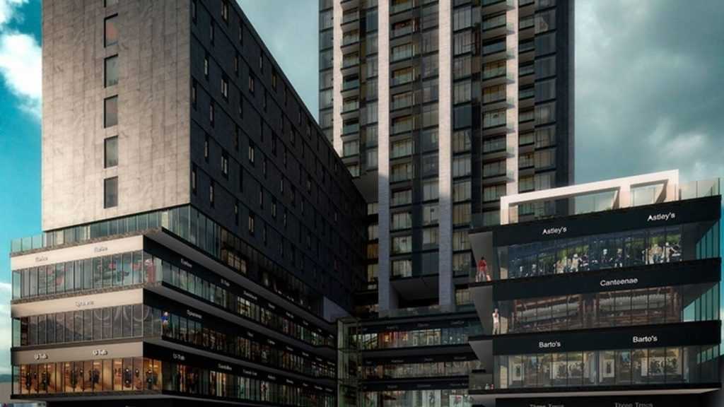 Contemporary Multi-level Shopping Podium Attached to a Tall Glass Residential Tower, with Storefronts and Brand Signs Visible. - Adelante Mty