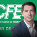 - Adelante Mty Man in a Navy Suit Poses in Front of a Green Cfe Backdrop with the Comisión Federal De Electricidad Logo. - Adelante Mty